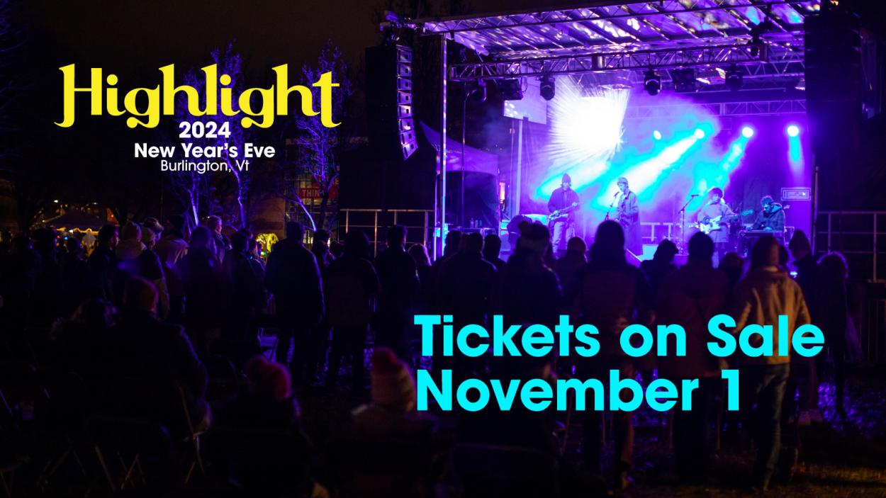 An outdoor stage at night, lit with blue and purple lights. Text promotes Highlight tickets being on sale November 1.